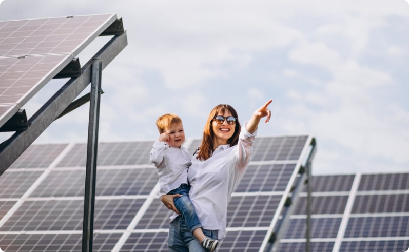 Mother with her son by solar panels.